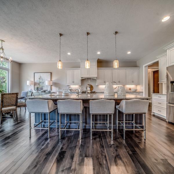 A modern custom-built kitchen and dining area with a large island and ample seating.