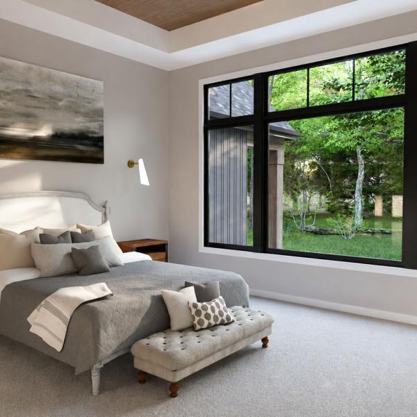 modern split-level primary bedroom with wood tray ceiling and large picture window