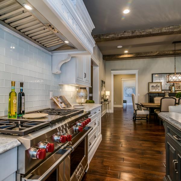 Kitchen and dining room that feels rustic, yet modern with high ceilings featuring wood beams.